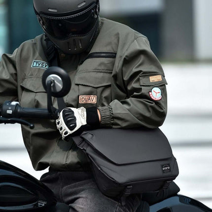 A person wearing a green jacket with a Hashiru Shoulder Bag and Cross Body Bag while riding a motorcycle.