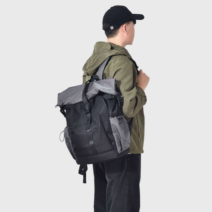 Sora Backpack for Biker, Mountain Climbing worn by a young man outdoors, showcasing ergonomic design and style.