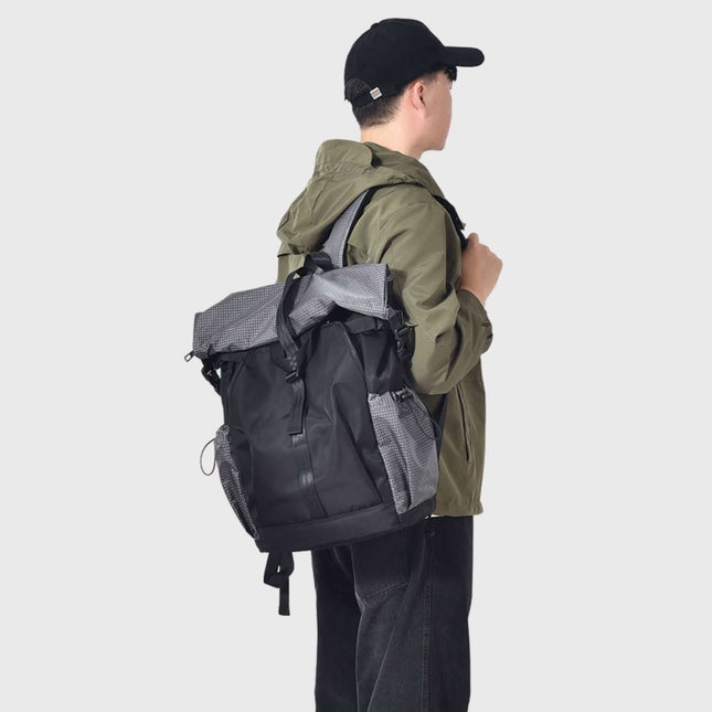 Sora Backpack for Biker, Mountain Climbing worn by a young man outdoors, showcasing ergonomic design and style.