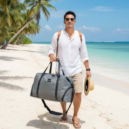 Man walking on a beach carrying a Bokken Travel Bag Large Capacity for a one week trip.
