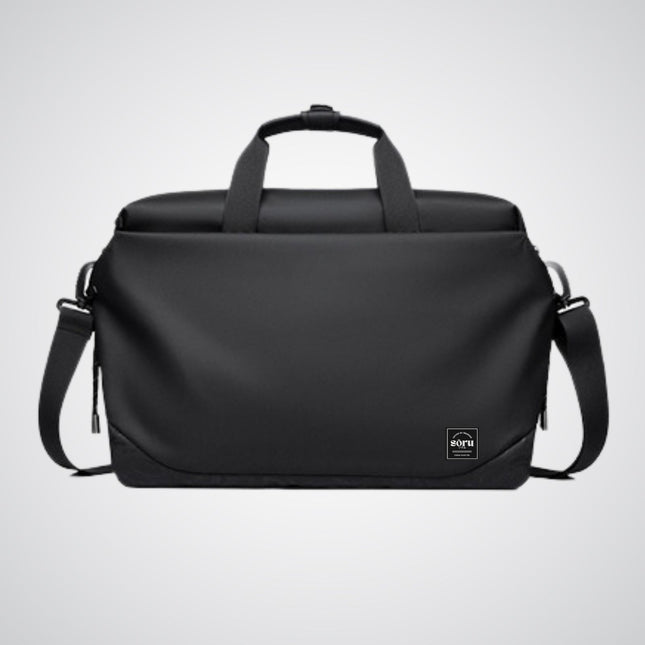 Black duffel bag with shoulder strap on a light gray background