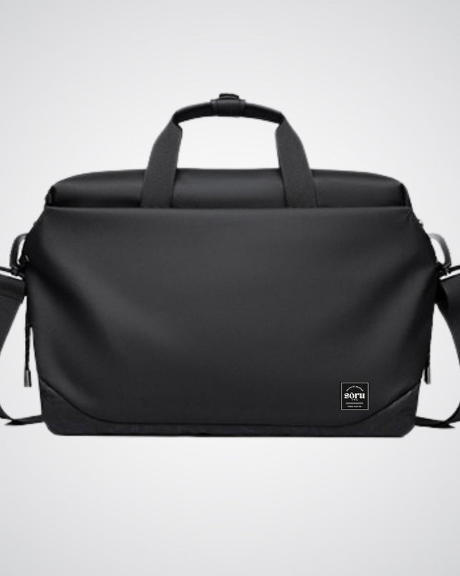 Black duffel bag with shoulder strap on a light gray background