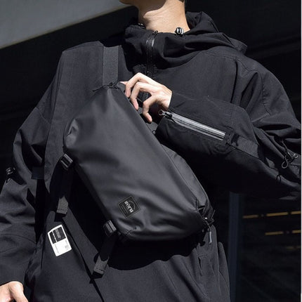 Noroi Cross Body Bag for Men Waterproof worn by a man in urban fashion outfit outdoors.