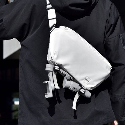 Noroi Cross Body Bag for Men Waterproof being worn by a person against a modern urban background.