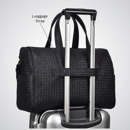 Limited Edition Kaze Woven Duffel Bag & Travel Bag with luggage strap on suitcase.