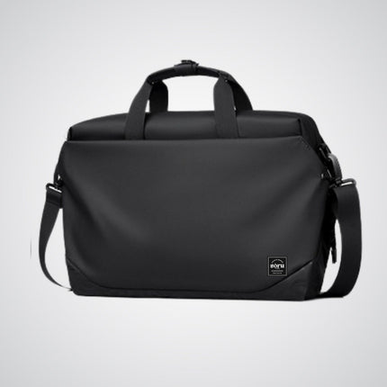 Black duffel bag with shoulder strap on a light gray background
