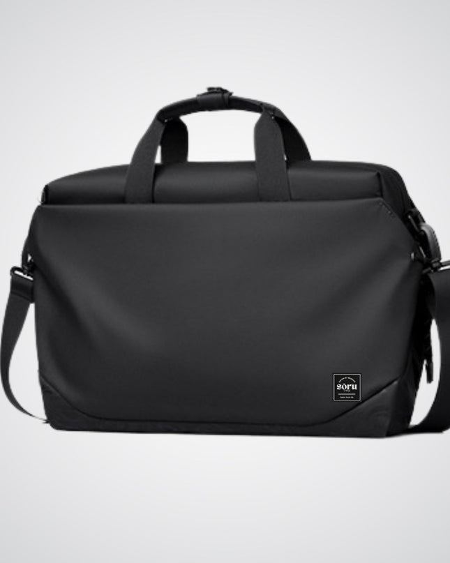 Black duffel bag with shoulder strap on a light gray background