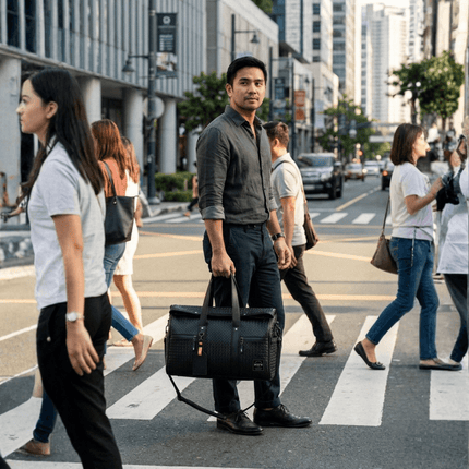 Limited Edition Kaze Woven Duffel Bag & Travel Bag being carried by a man crossing a busy street.