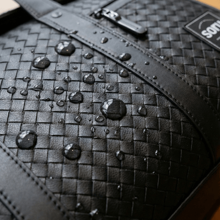 Close-up of the Limited Edition Kaze Woven Duffel Bag & Travel Bag showing water-resistant surface with droplets.
