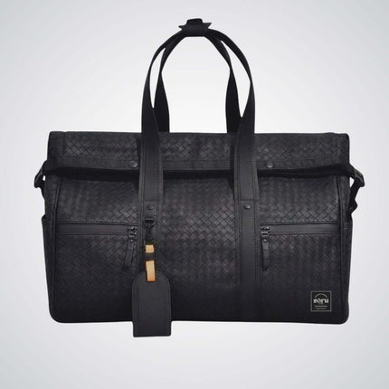 Limited Edition Kaze Woven Duffel Bag & Travel Bag in sleek black design with roll-top fold and spacious compartments.