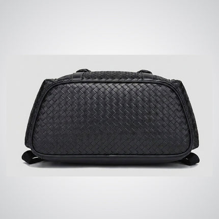 Black woven duffel bag on a light gray background