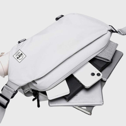 Noroi Shoulder Bag and Cross Body Bag with essentials including phone, tablet, and notebook neatly stored inside.