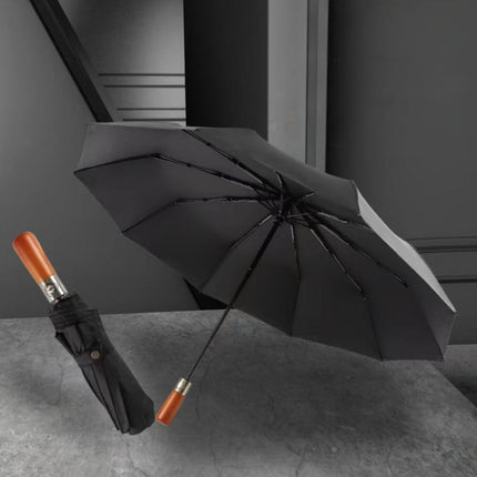 Amaya Tri-Fold Umbrella displayed in black with a wooden handle and sturdy ribs for durability.