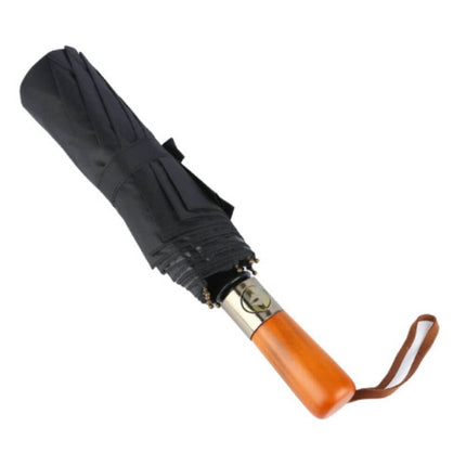 Amaya Tri-Fold Umbrella folded with elegant wooden handle and black fabric for superior sun and wind protection.